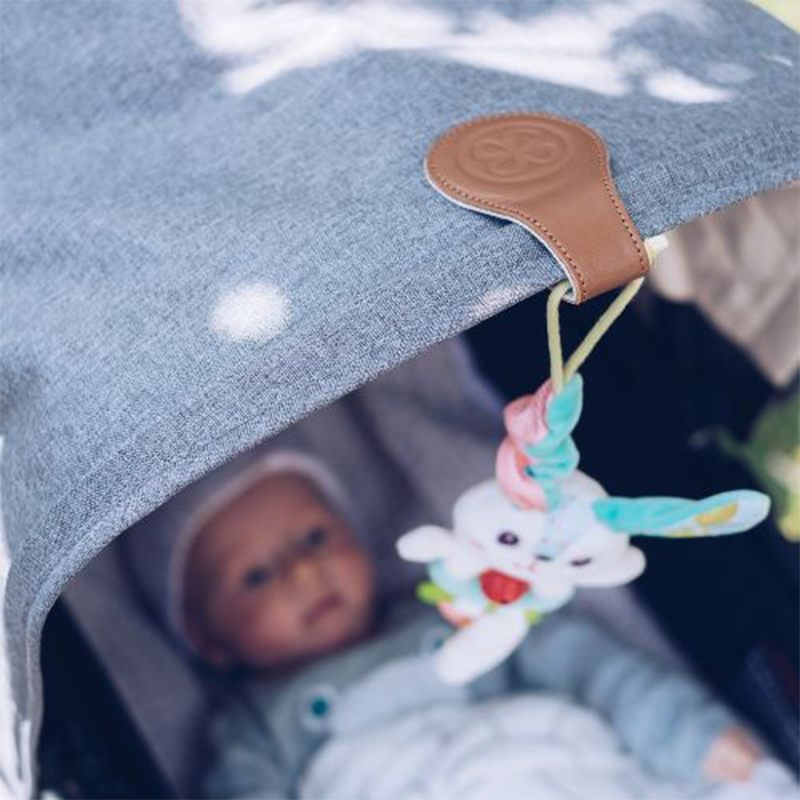 Spielzeug befestigt am Kinderwagen mit braunem Magnetclip von Cloby.