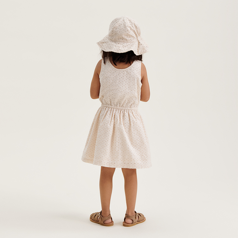 Mädchen trägt das Liewood Kleidchen &#39;Idaho&#39; in der Farbe Sandy von Hinten.